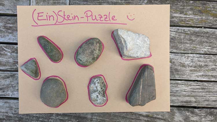 Ein einfaches Legepuzzle ist schnell mit ein paar Steinen und einem Fasermaler gebastelt.