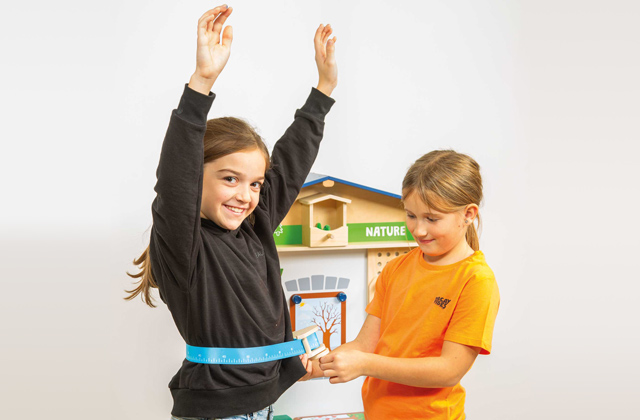 Kinder spielen mit dem Maßband von beleduc